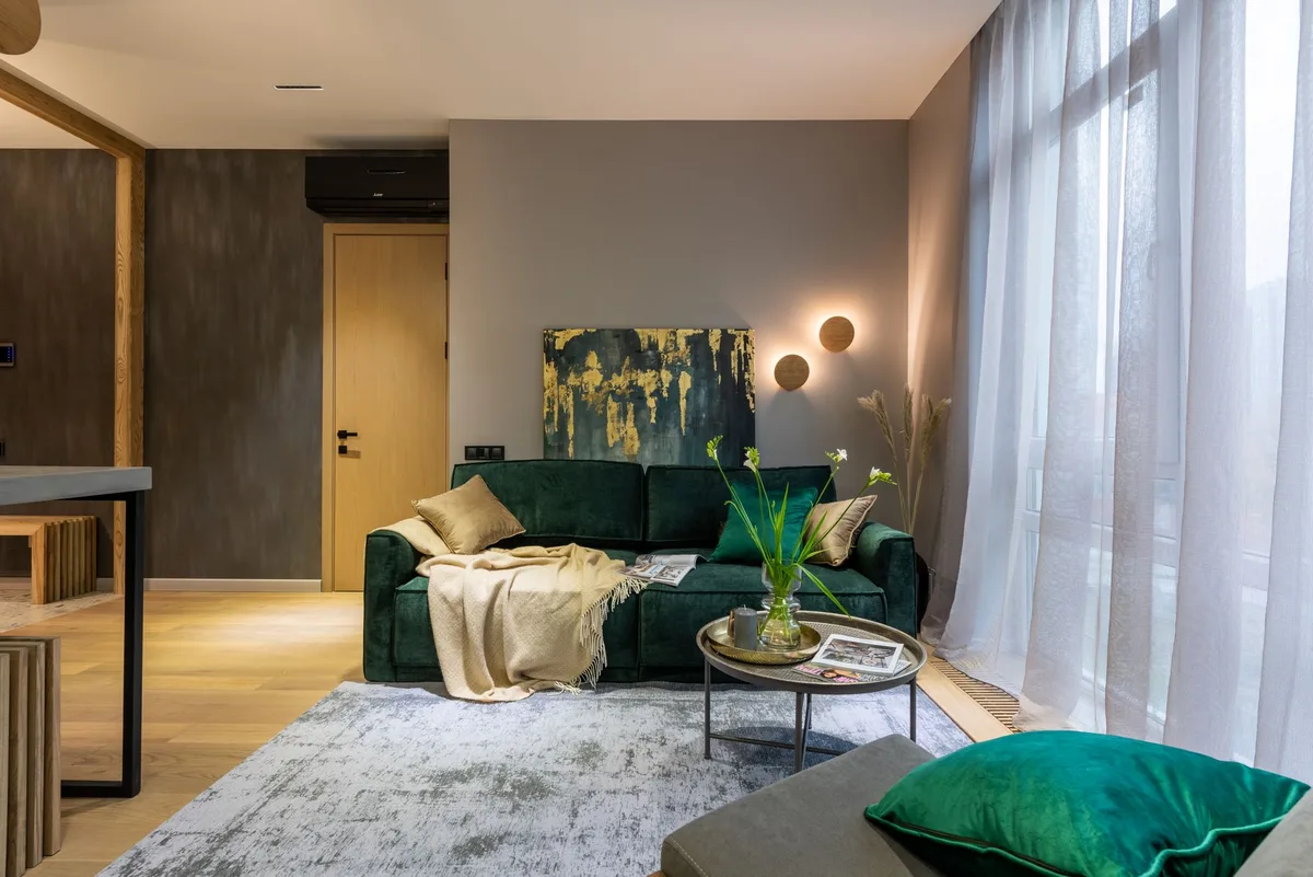 Airbnb management Bangkok, modern condominium living room with a green velvet sofa