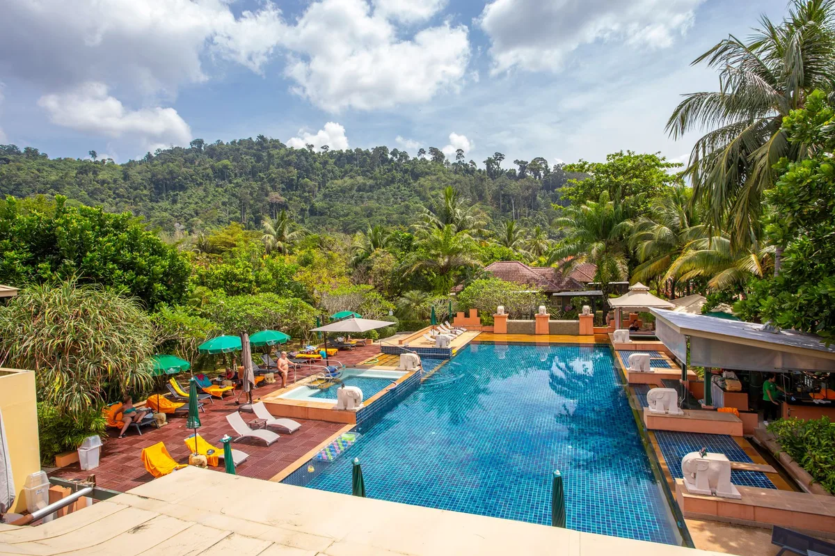 Koh Samui villa rental management, hillside resort pool among palms above the sea