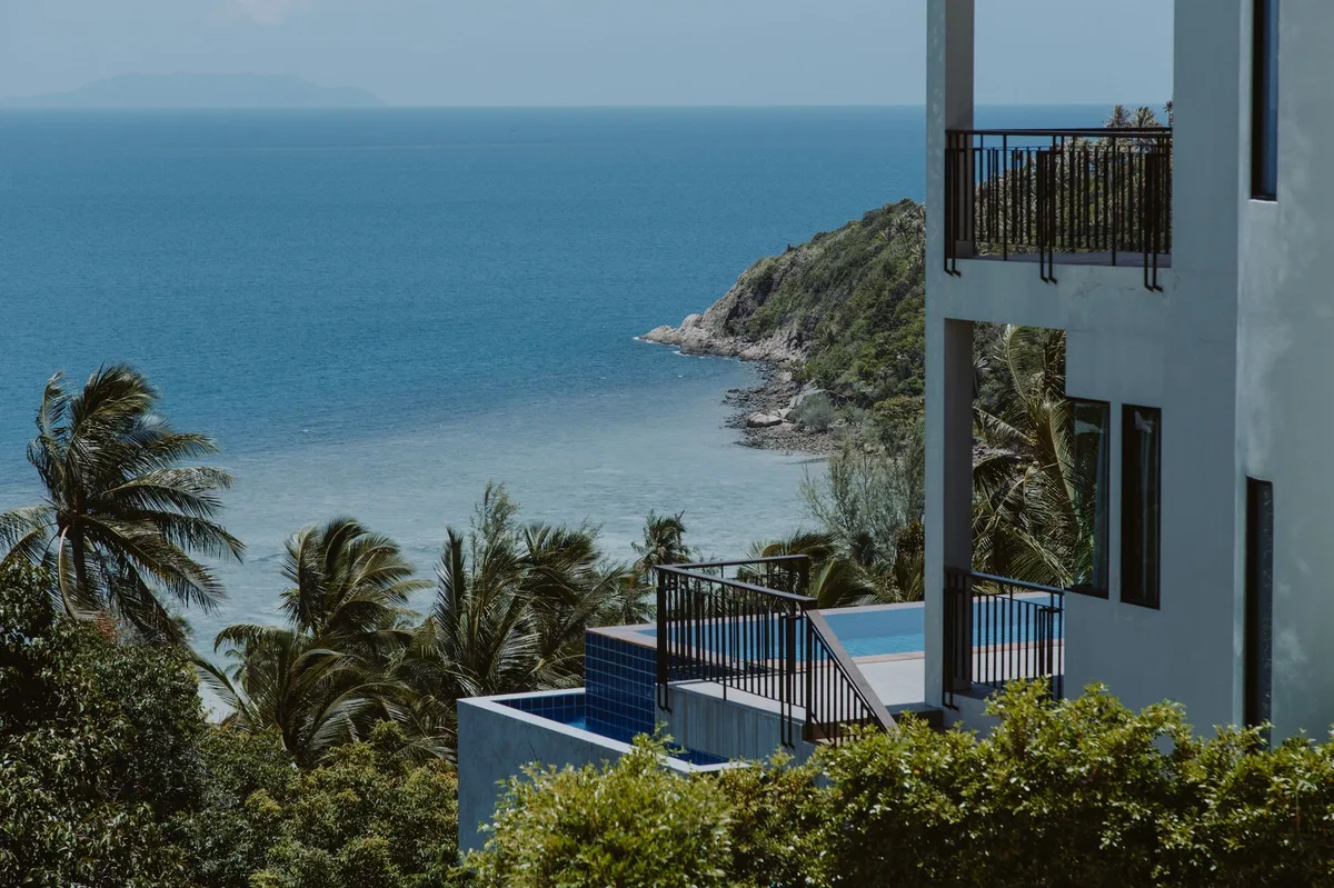 Phuket luxury villa management, villa terrace overlooking a bay and headland