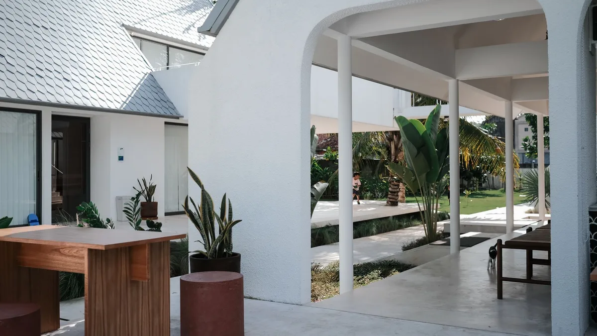 Villa management Thailand, white villa exterior with a covered walkway