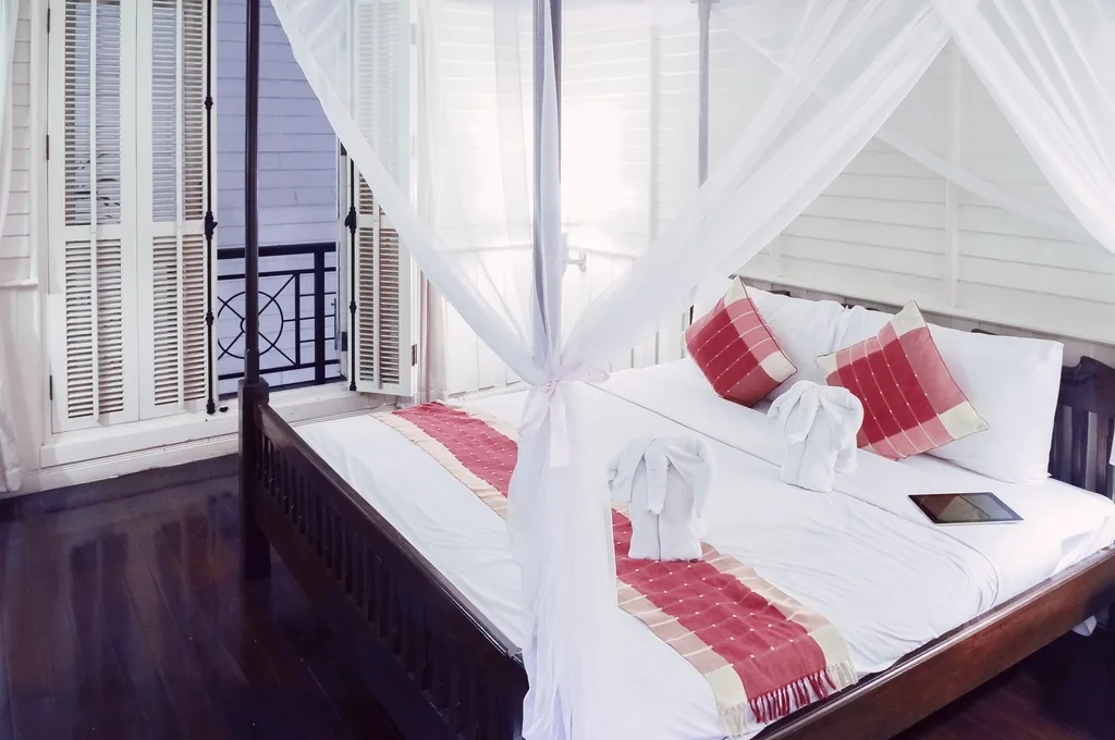 Bedroom made up with white linen