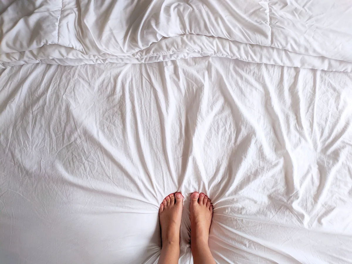 Bedroom made up with white linen