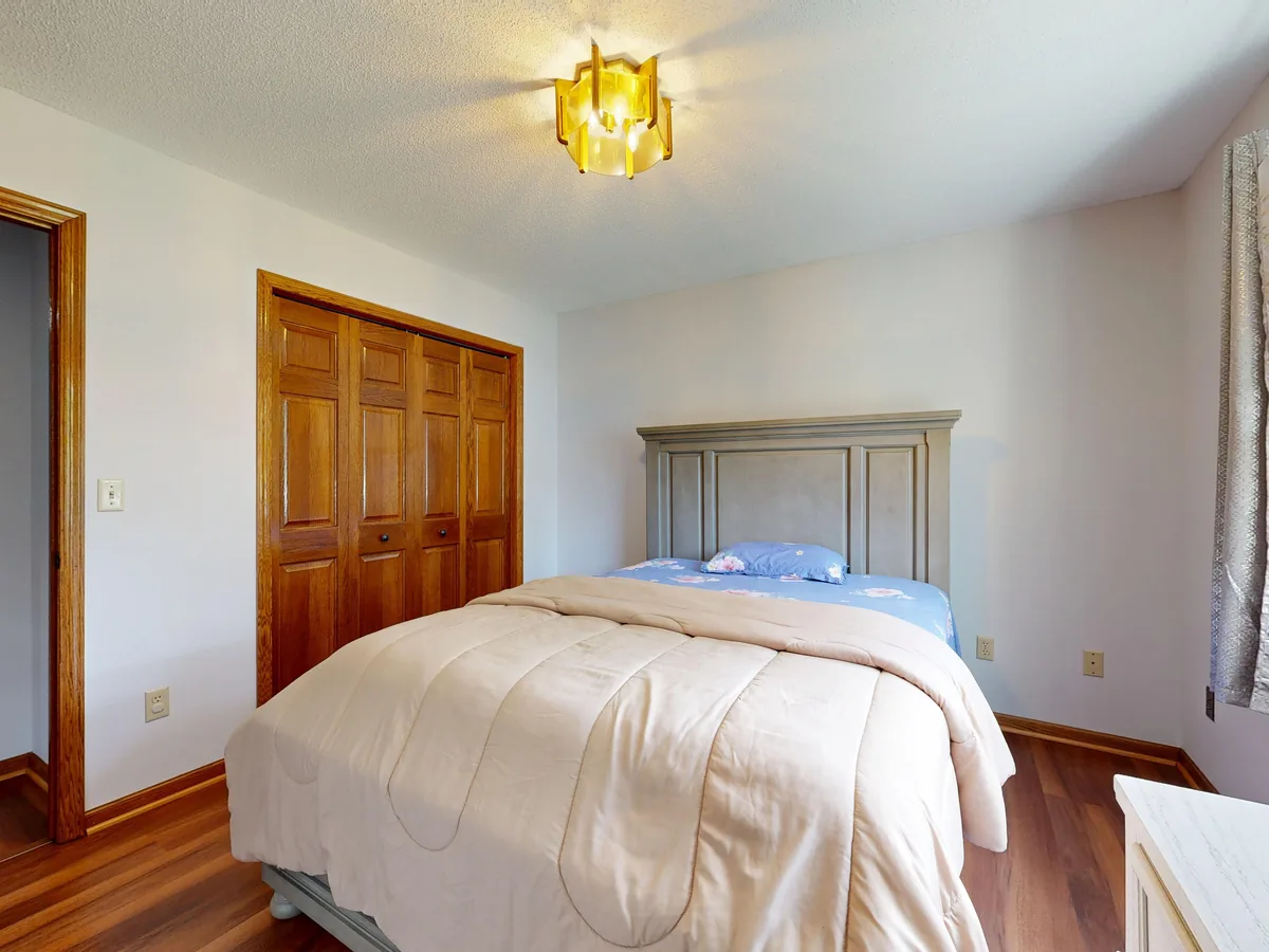 Bedroom made up with white linen