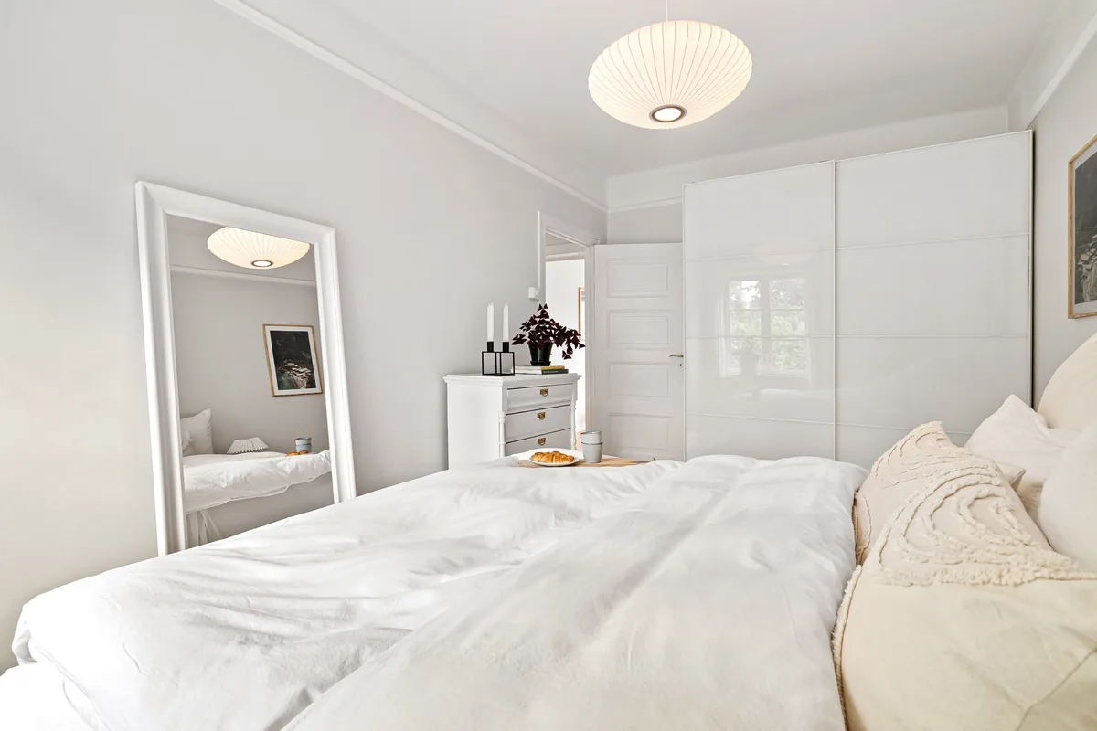 Bedroom made up with white linen
