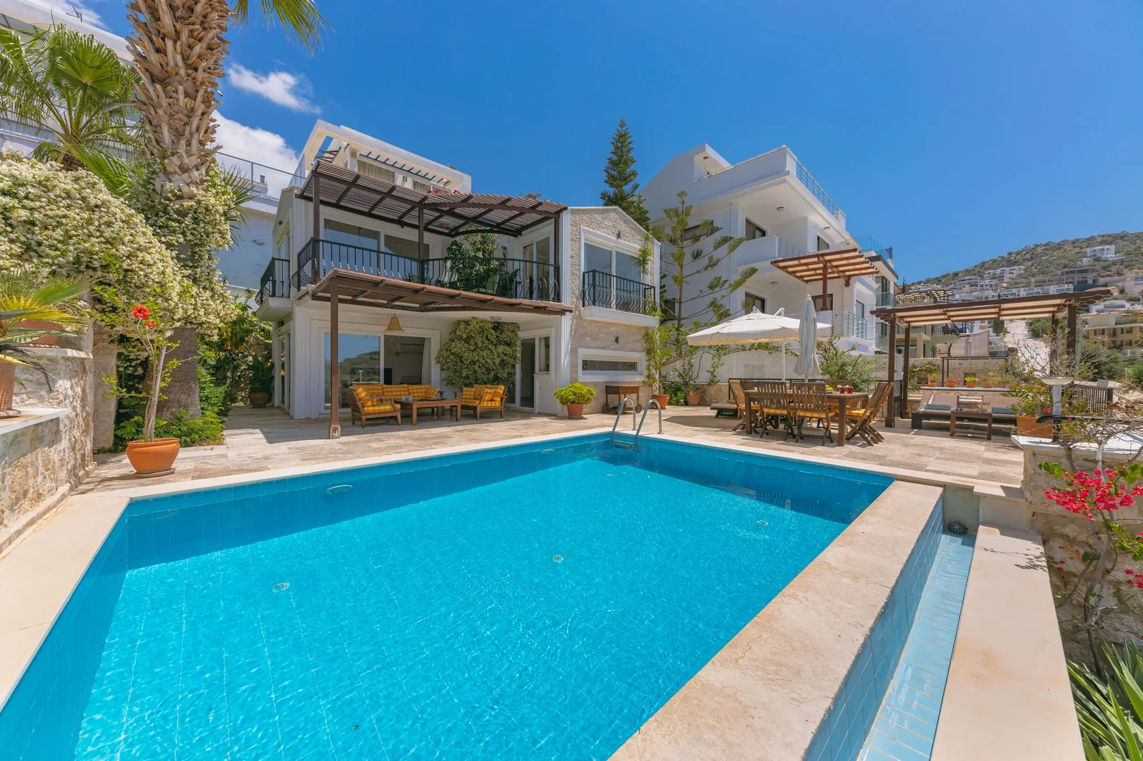 Villa with a swimming pool and a shaded terrace