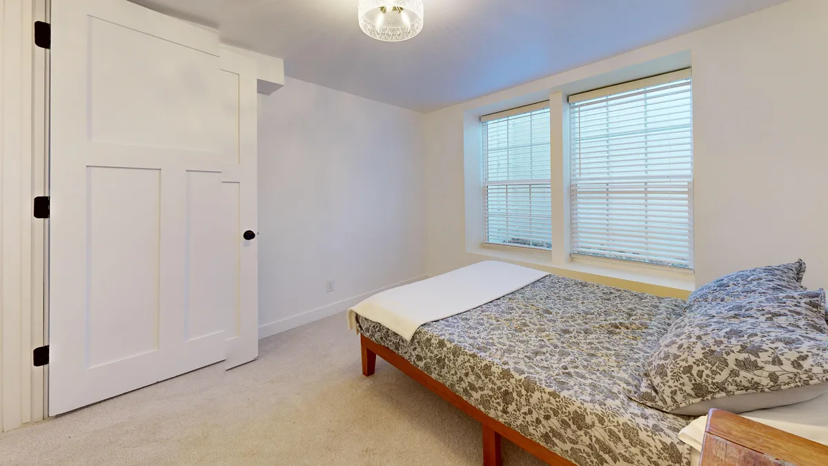 Bedroom made up with white linen