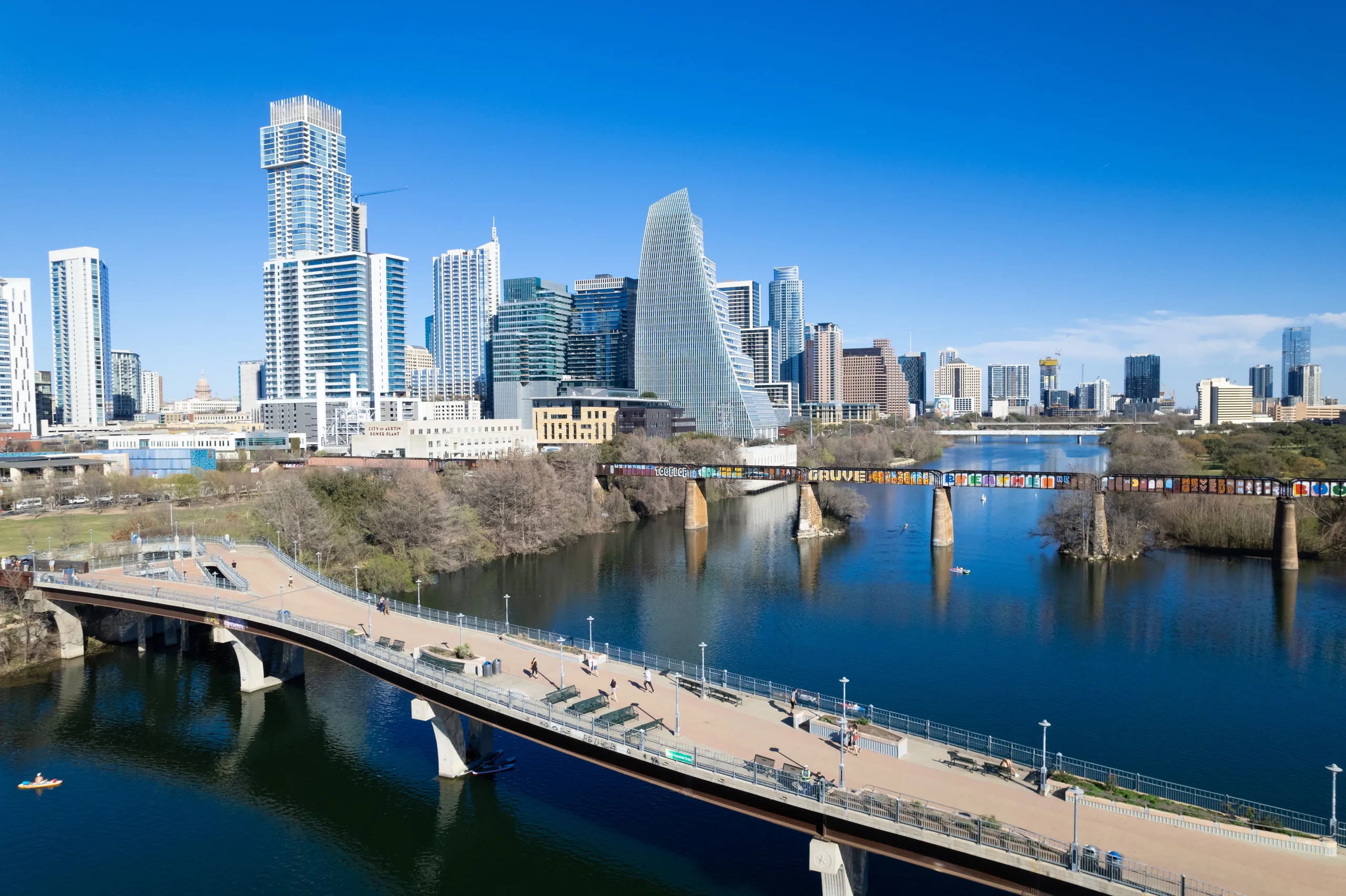 Downtown Austin skyline and bridges over Lady Bird Lake on a sunny day