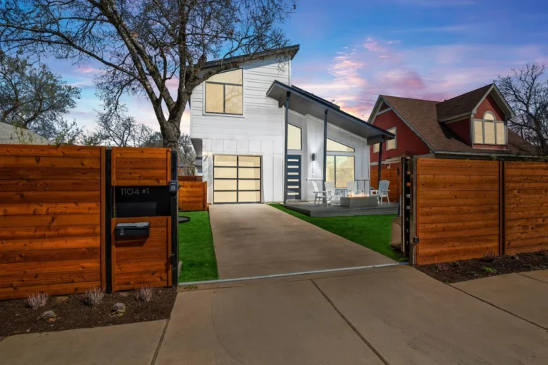 Modern two-storey house behind a wooden fence in Austin