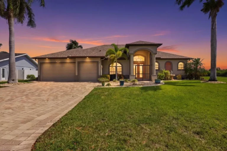Cape Coral vacation home front exterior with lawn and driveway at dusk