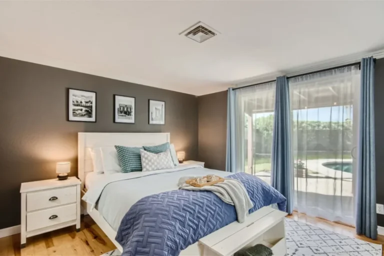 Bedroom with a white bed frame and glass doors at a Chandler vacation home