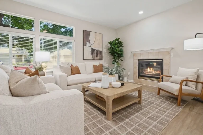 Living room with a fireplace and pale sofas in our Davis home