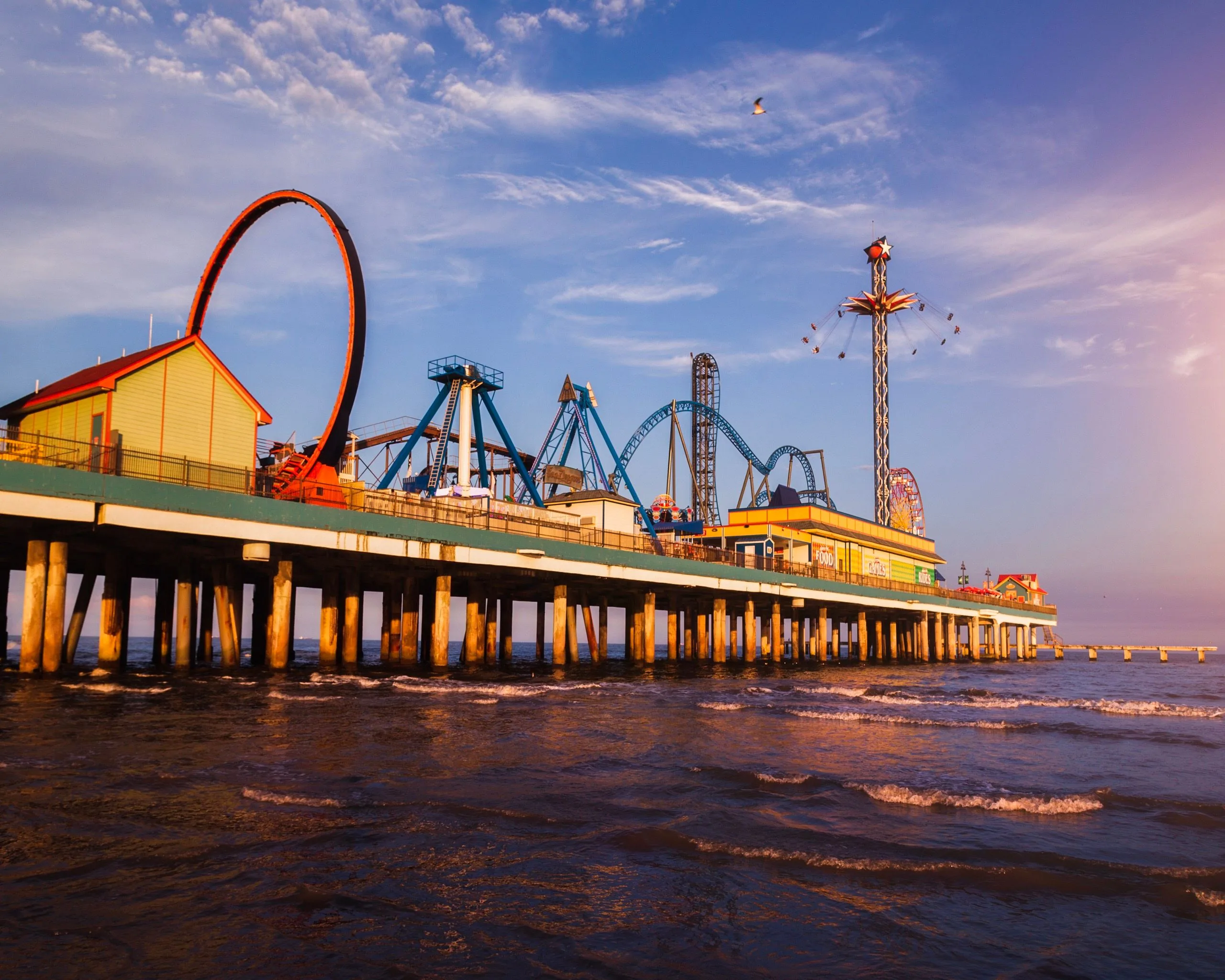 Sunlit rides above the Gulf at Galveston Historic Pleasure Pier