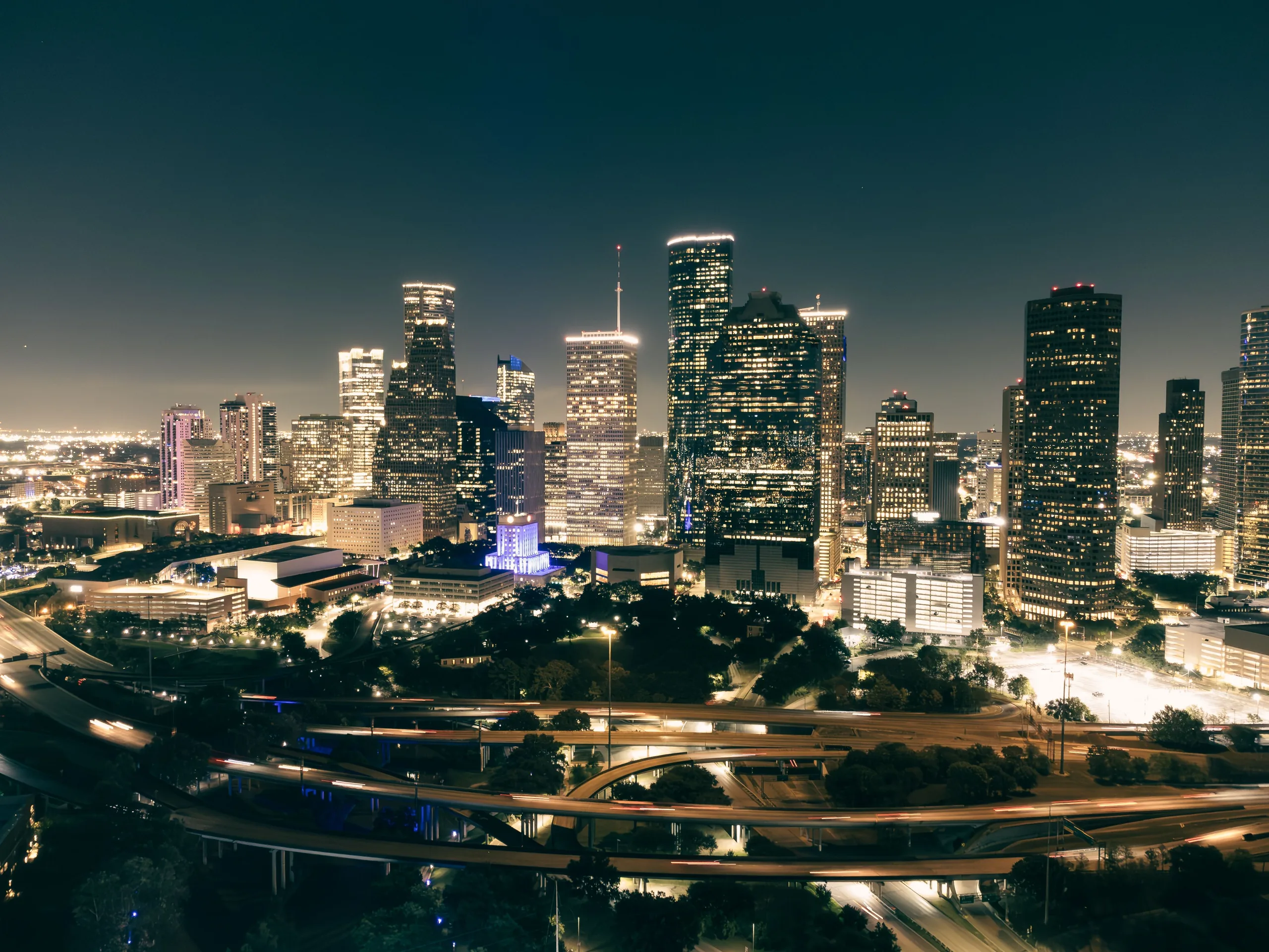 Houston skyscrapers and highways illuminated at night