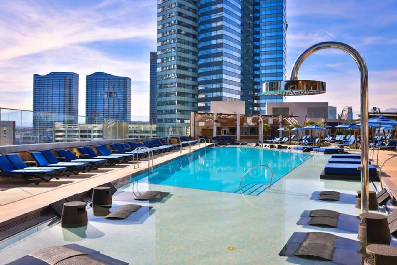 Rooftop pool with loungers beside high-rise towers in Las Vegas
