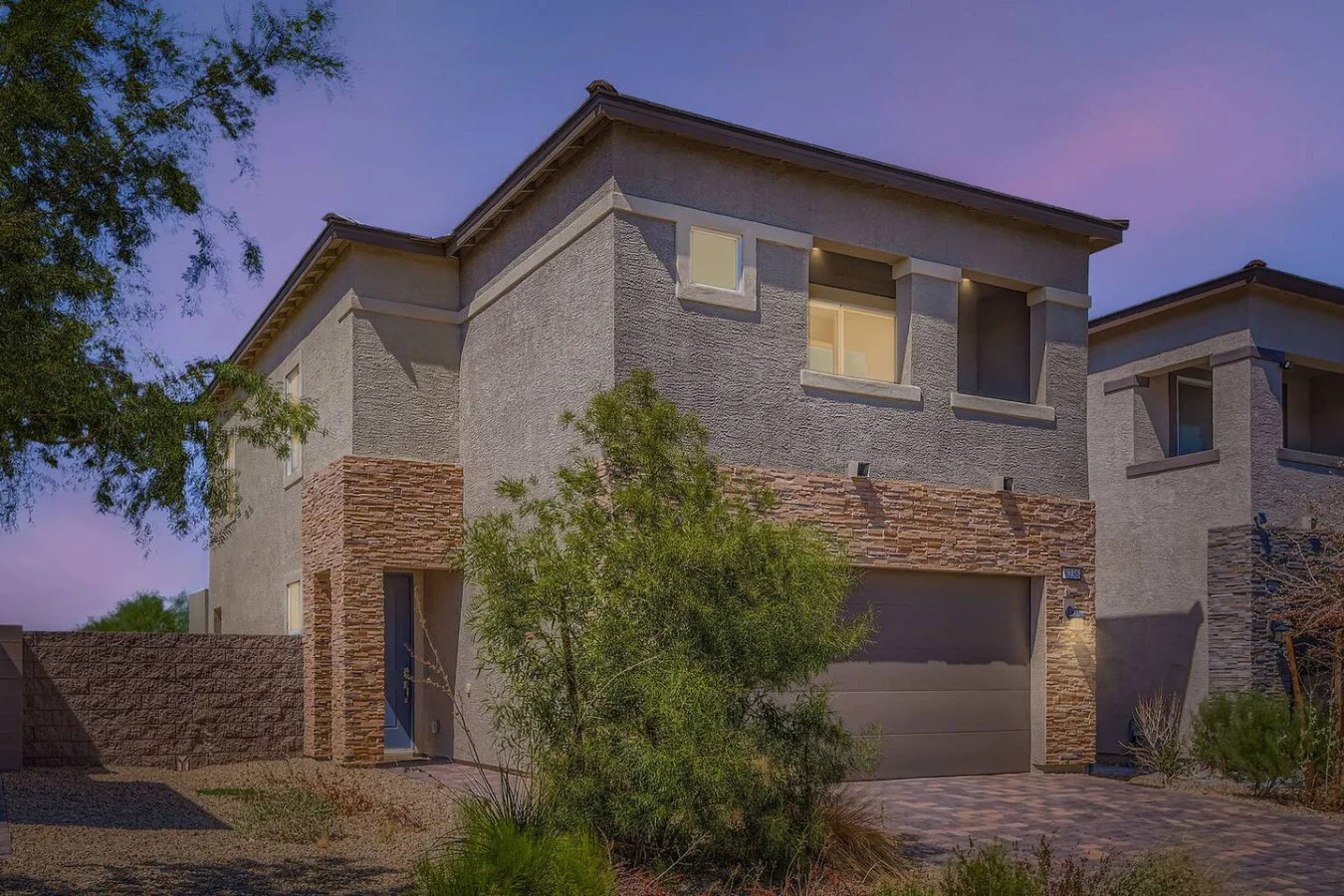 Two-storey stucco house at dusk in Las Vegas
