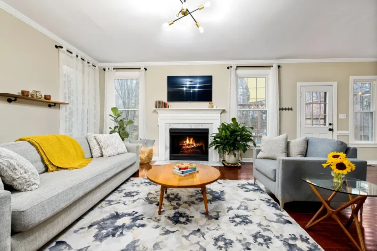 Bright living room with a fireplace and a grey sofa