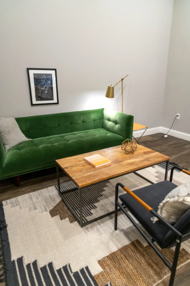 Living room with a green sofa and wooden table