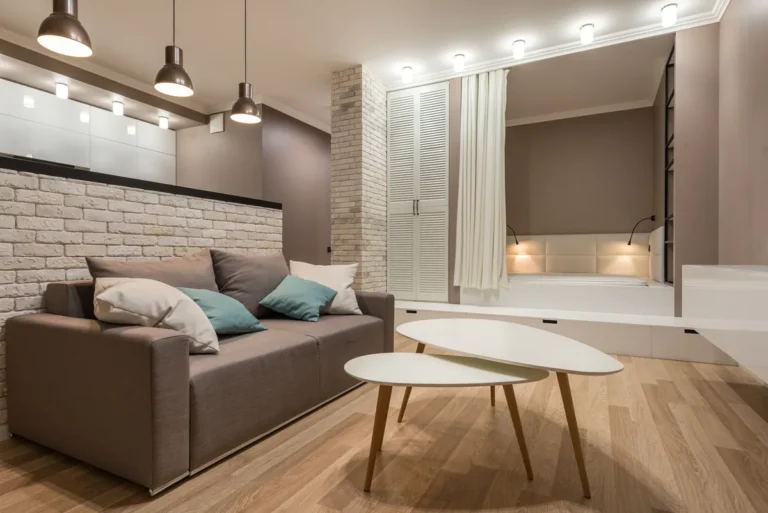 Spacious living room beneath pendant lights