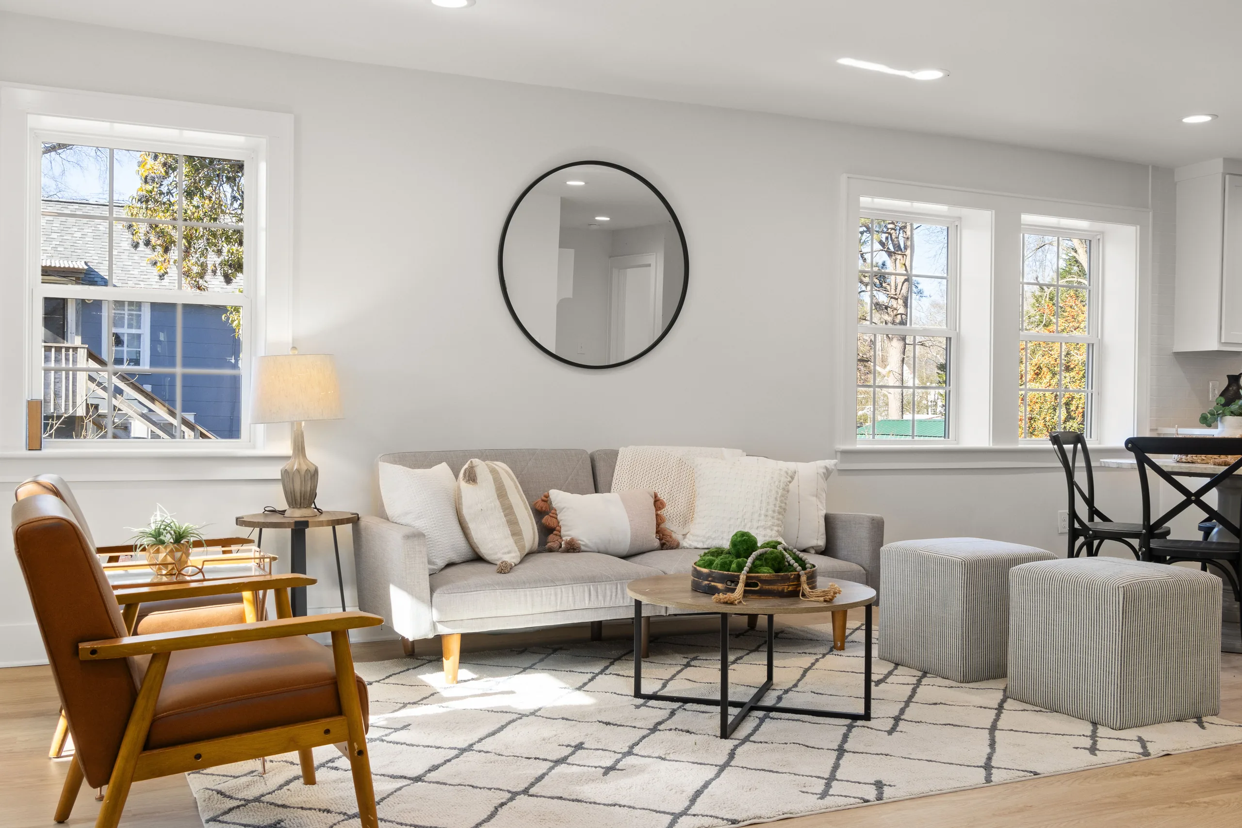 Sunlit living room with pale furniture and large windows