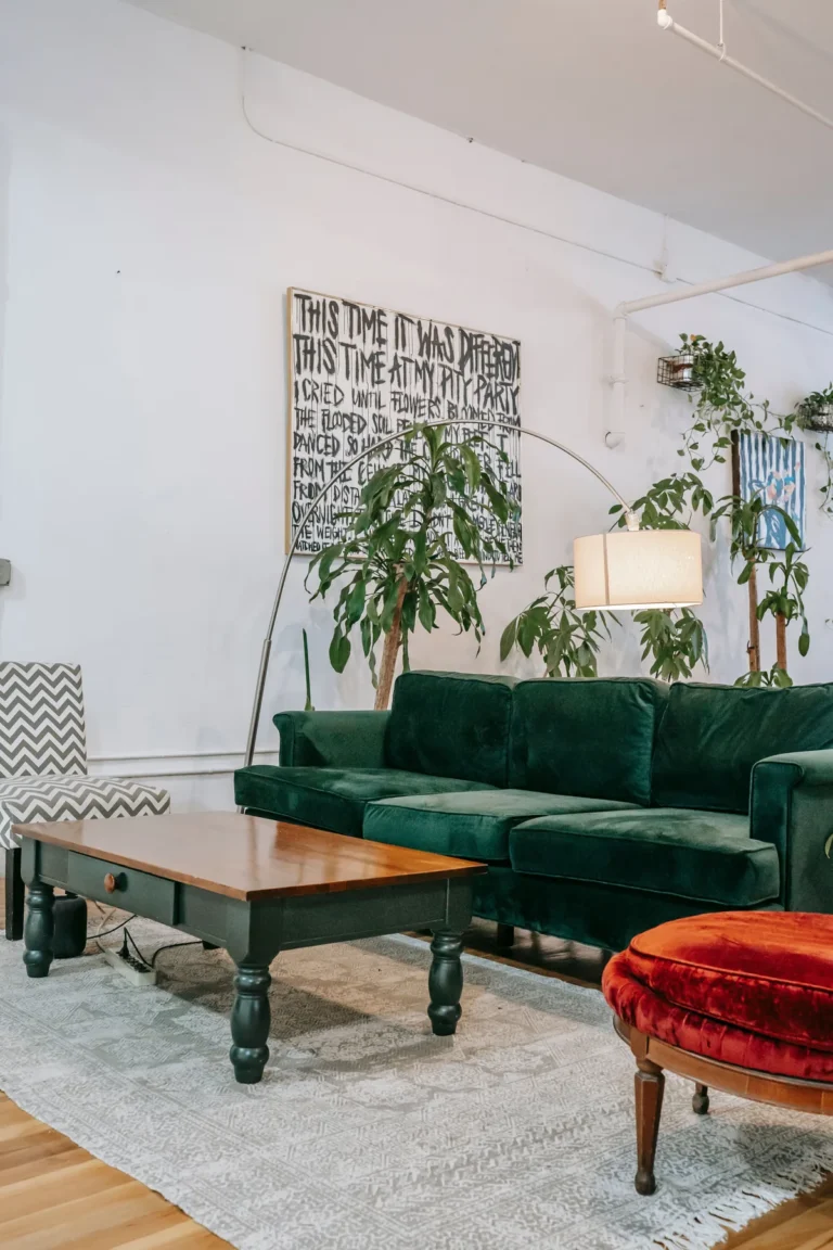 Furnished living room with plants and a green sofa