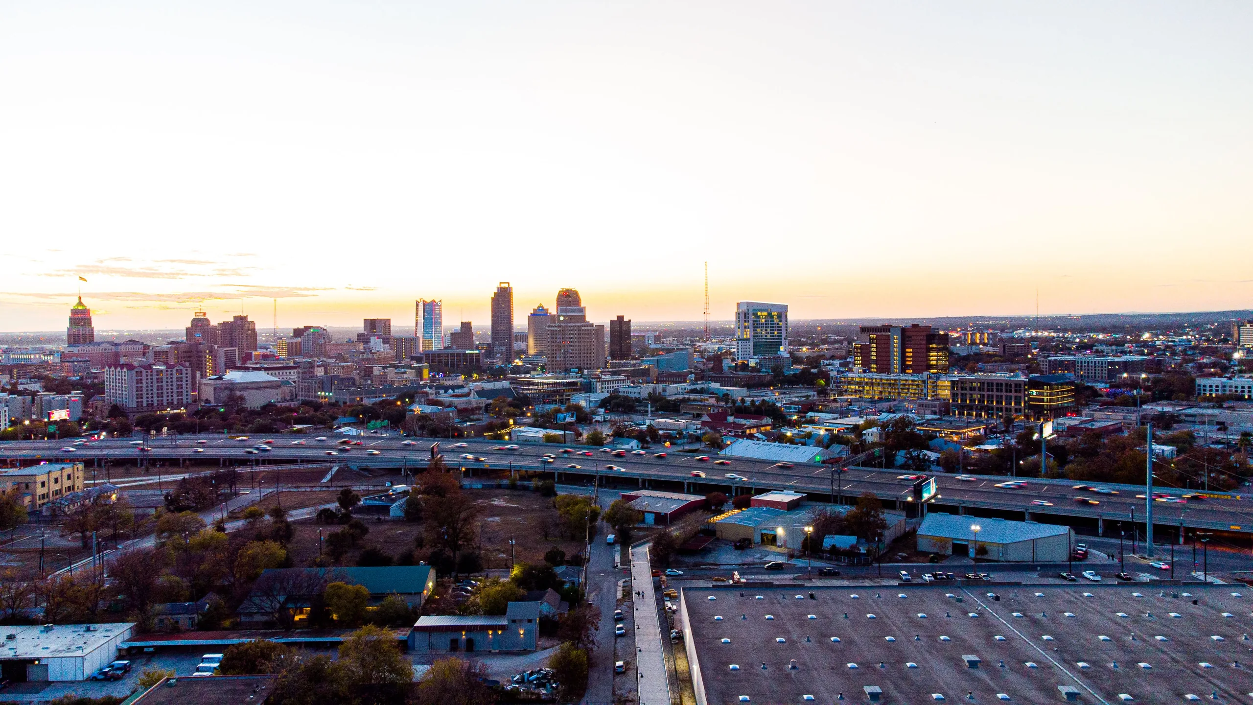 San Antonio skyline beyond the highway at sunset