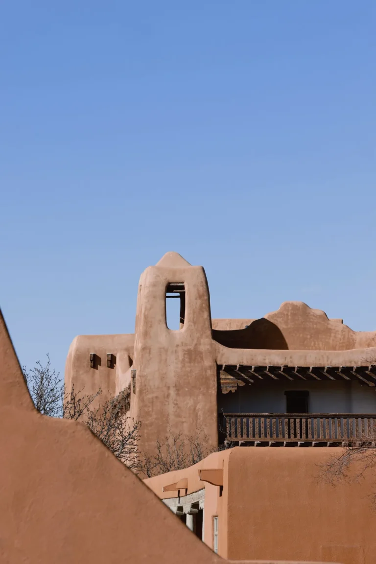 Sunlit adobe walls and a balcony in Santa Fe