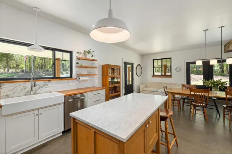 Bright kitchen with marble countertops and pendant lights