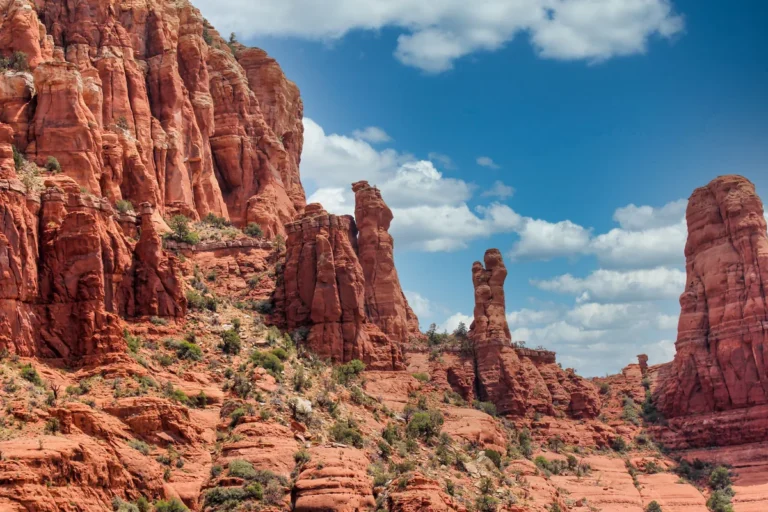 Sedona red rock cliffs beneath scattered clouds