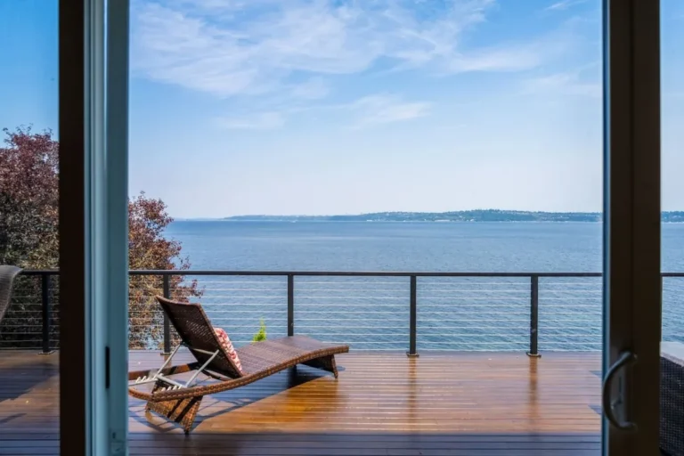 Deck lounge chair and water view through the windows of our Vashon home