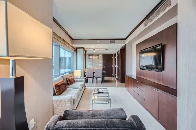 Vdara living and dining space with a sofa, television and kitchen beyond