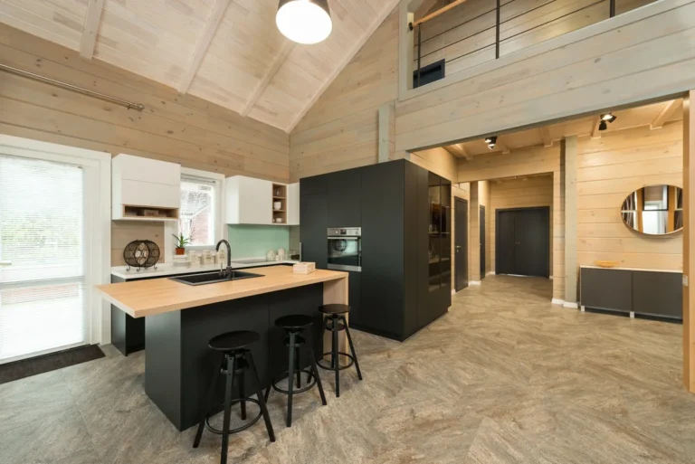 Kitchen island and wood-panelled walls in a modern mountain chalet